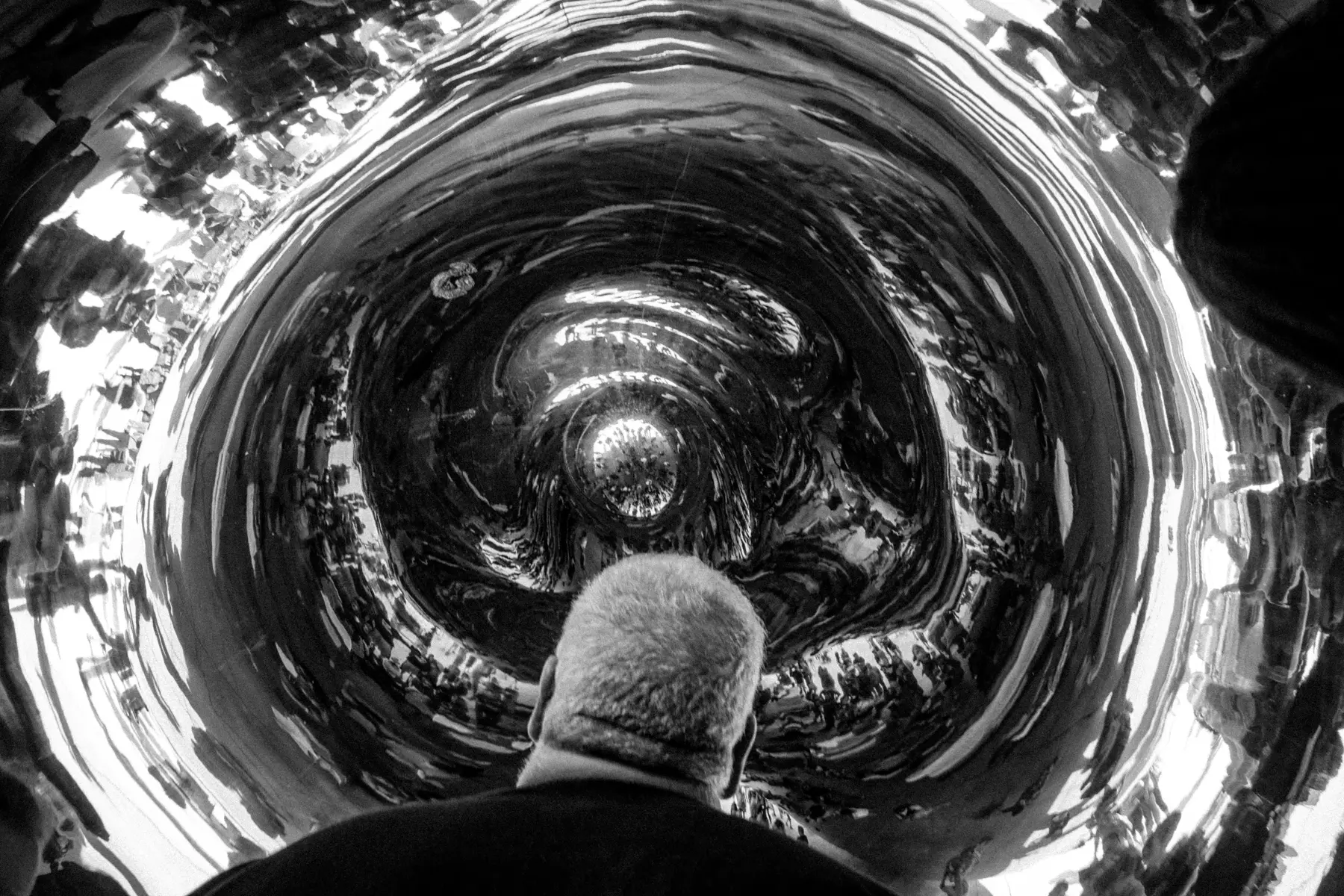 a man looking at the bean at millenial park in Chicago